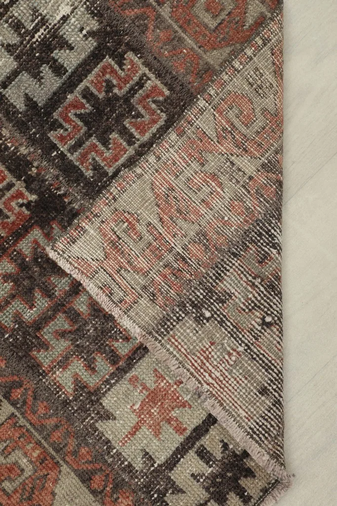 View of the rug's backside, revealing the hand-knotted cotton foundation and wool knots