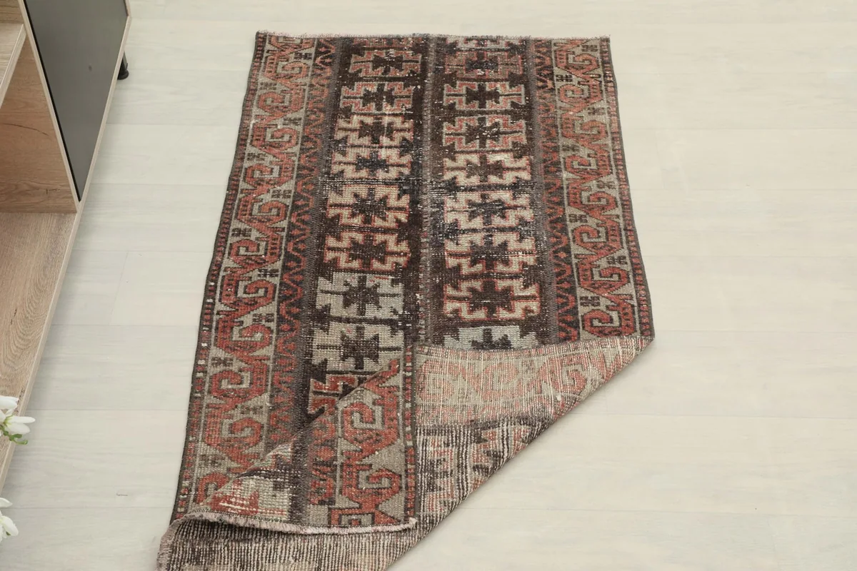 Rug partially folded, illustrating its flexibility and construction