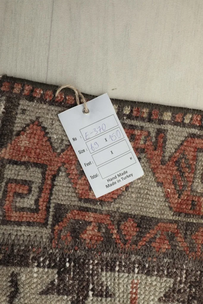 Close-up of the rug's label, confirming its hand-made origin in Turkey and dimensions