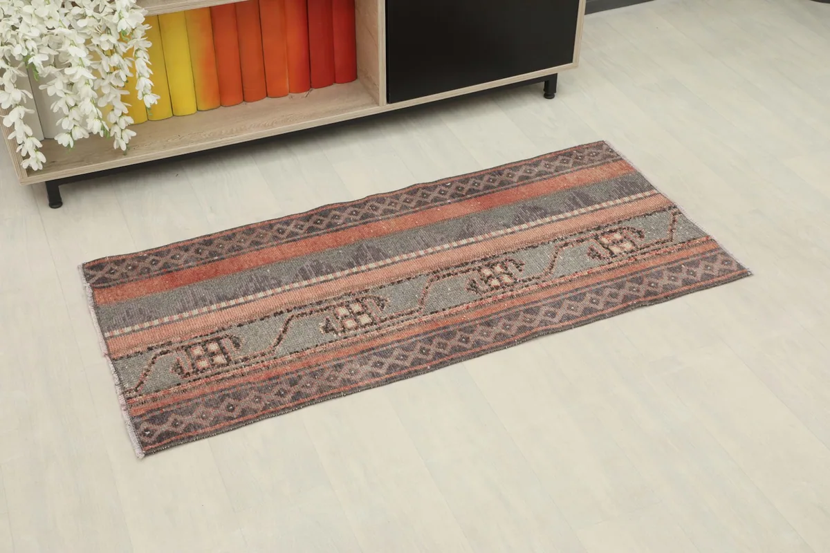 Vintage Anatolian runner displayed in a room setting, showing its scale and striped pattern.