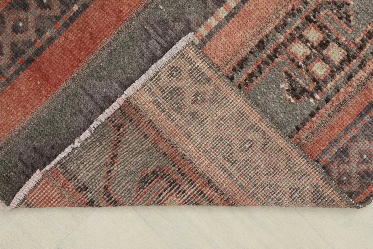 Close-up of the back of the hand-knotted wool rug, revealing the cotton foundation.