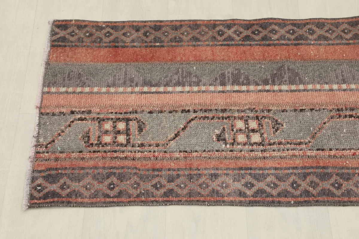 Overhead view focusing on the central striped pattern and geometric elements of the rug.