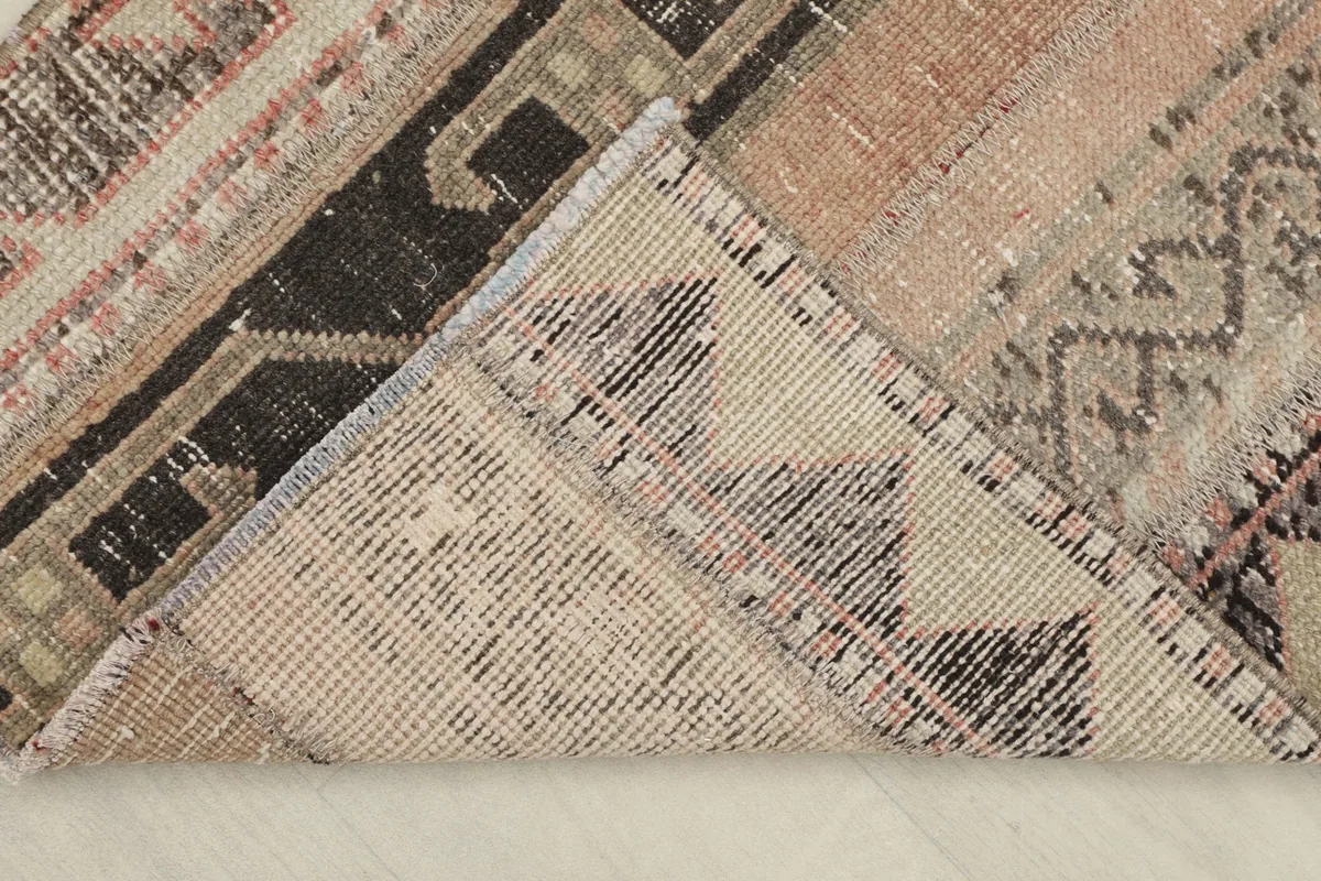 View of the back of the hand-knotted wool pile rug, showing the cotton foundation and knotting.