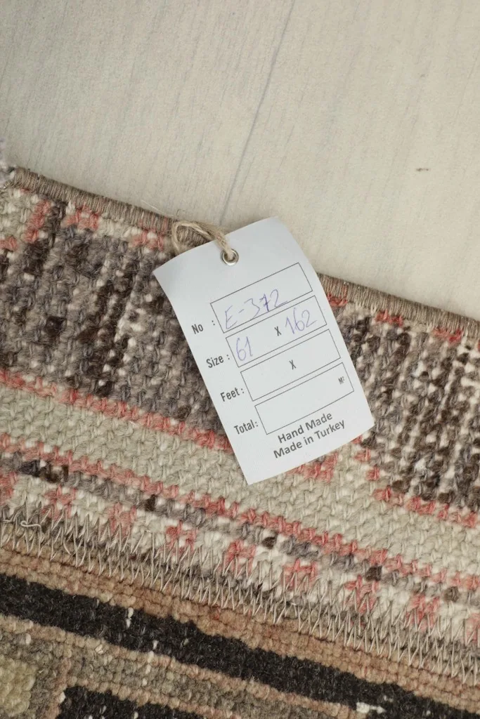 Close-up of the rug's label, showing the dimensions and 'Hand Made in Turkey' information.