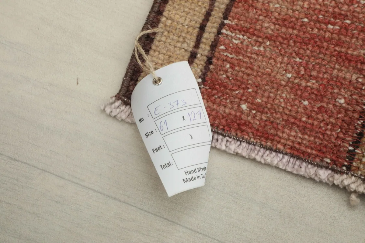 Close-up of the rug's corner with a tag displaying size and origin information
