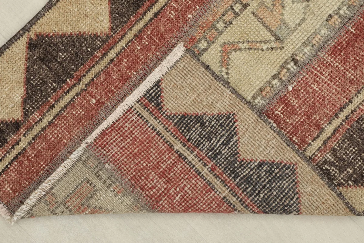 View of the back of the hand-knotted wool runner, showing the cotton foundation.