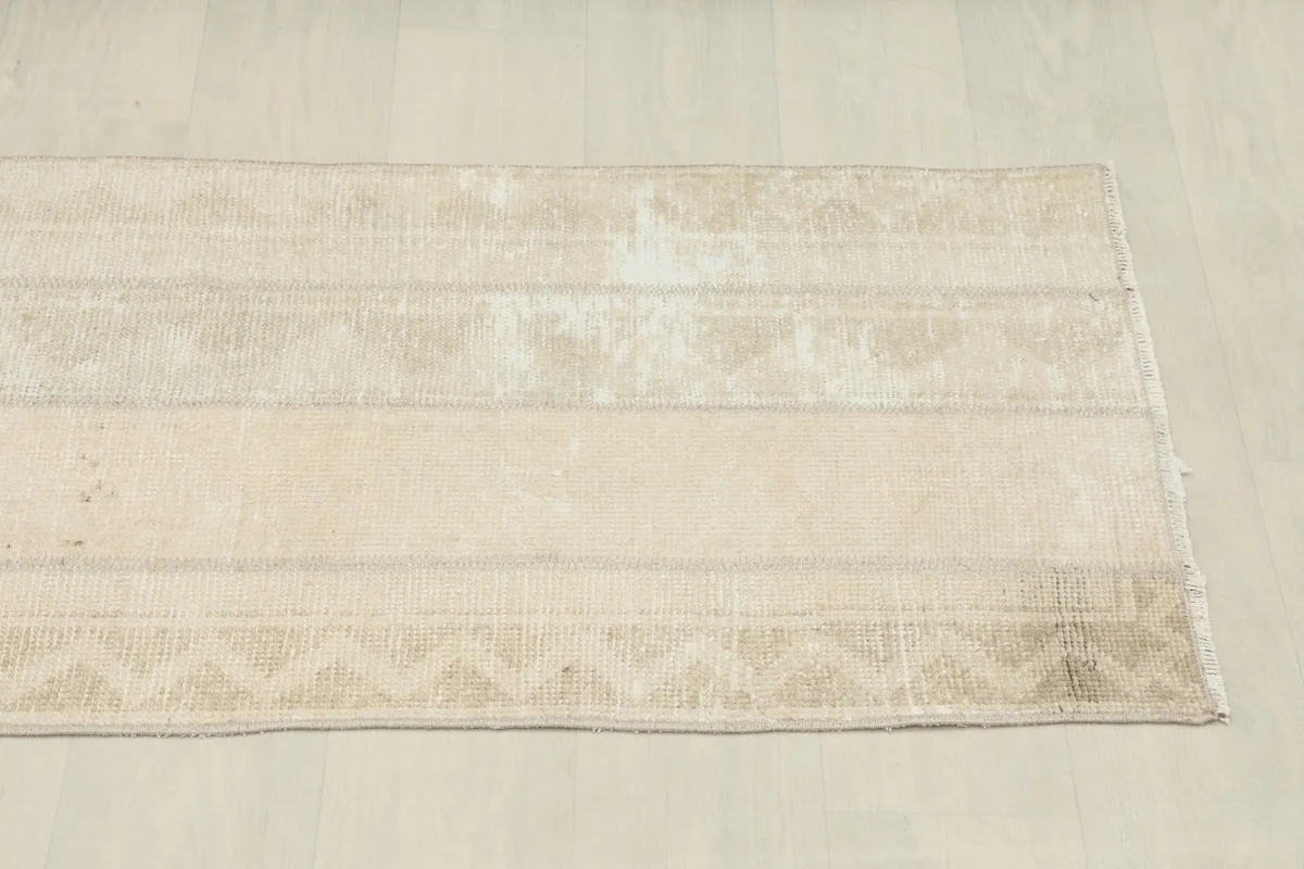 Another angled view, capturing the full length of the rug and its muted color variations.