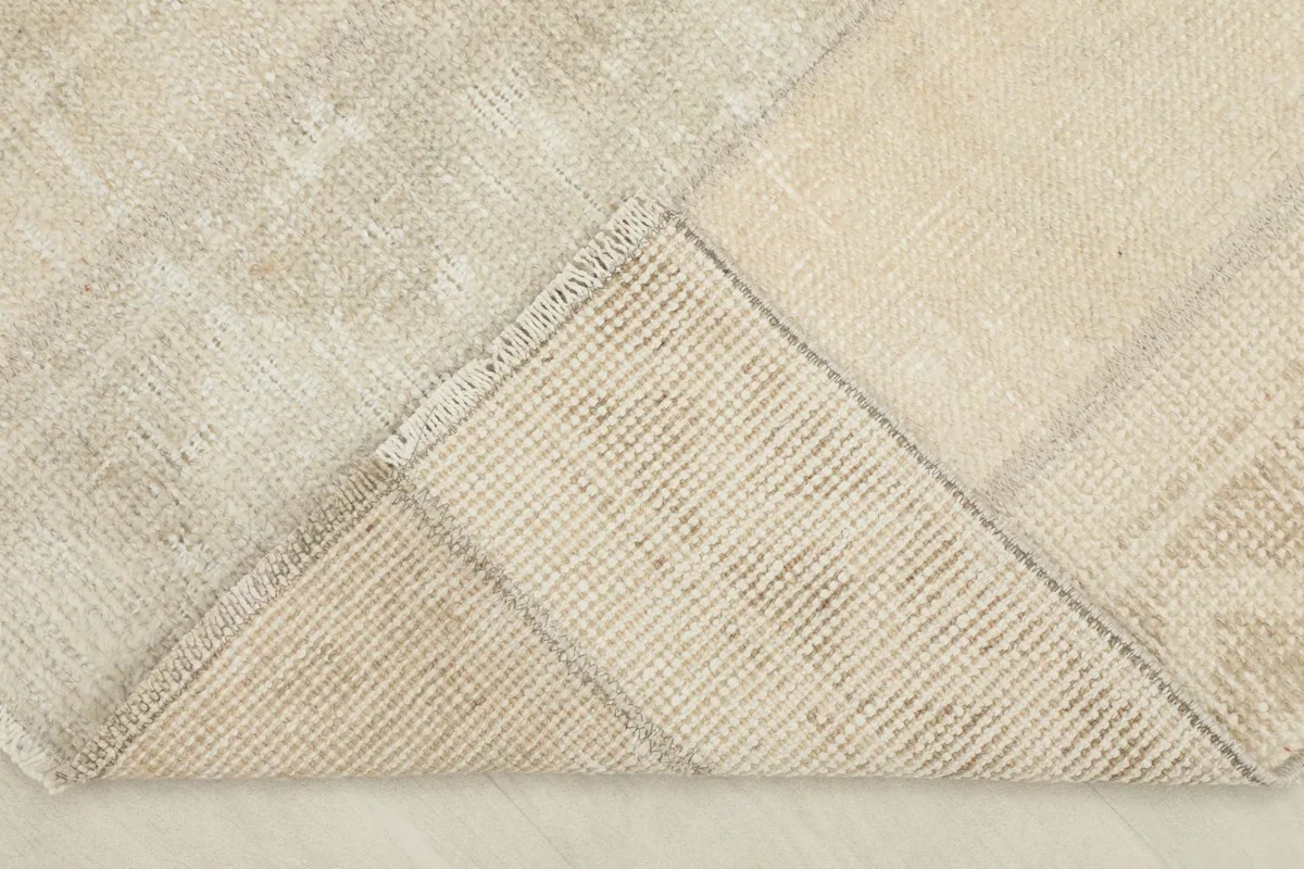 View of the rug's underside, revealing the cotton foundation and hand-knotted construction.
