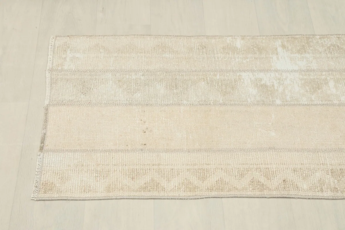 Overhead view of the rug, emphasizing its elongated shape and striped geometric design.