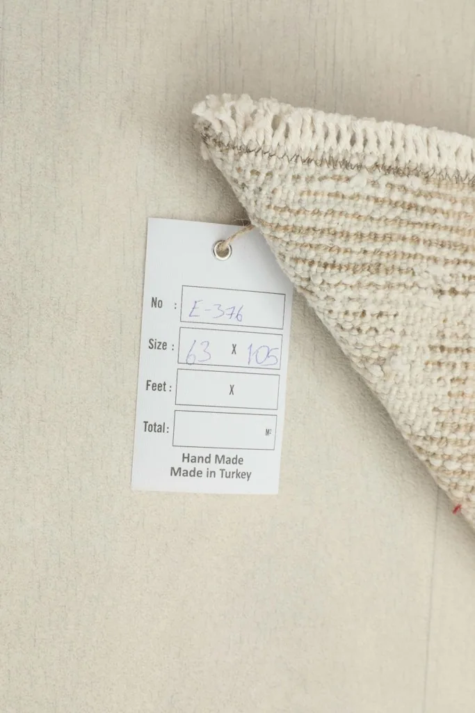 Close-up of the product tag, confirming the rug's size and handmade origin from Turkey.