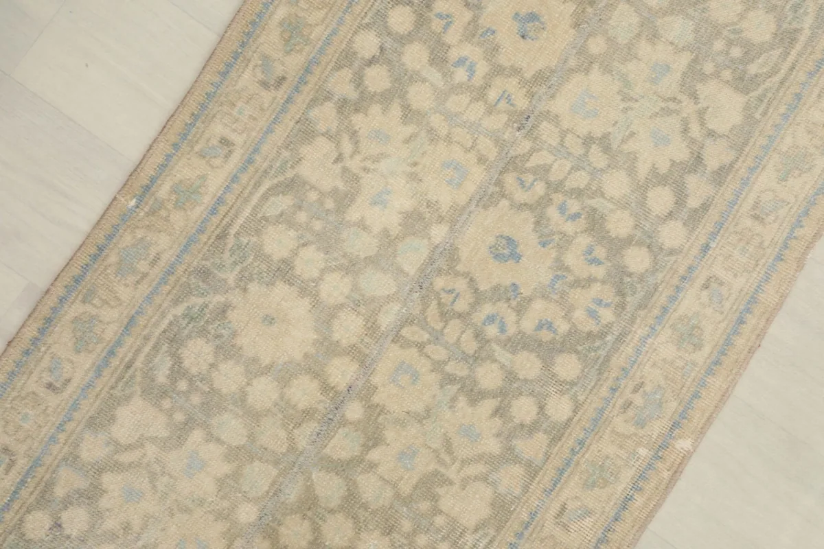 Close-up overhead view highlighting the cream and blue floral motifs and the subtle color variations.
