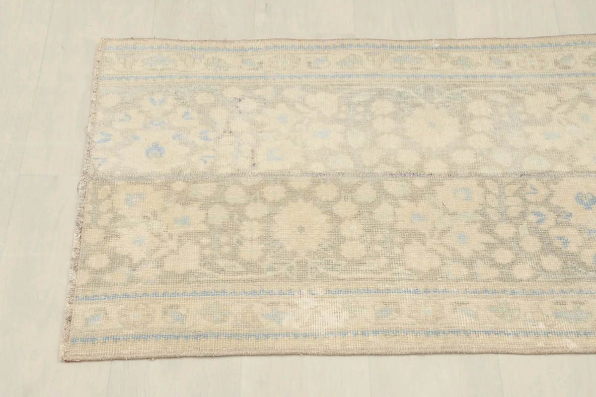 Overhead view from one end of the rug, showcasing the full pattern repeat and border.