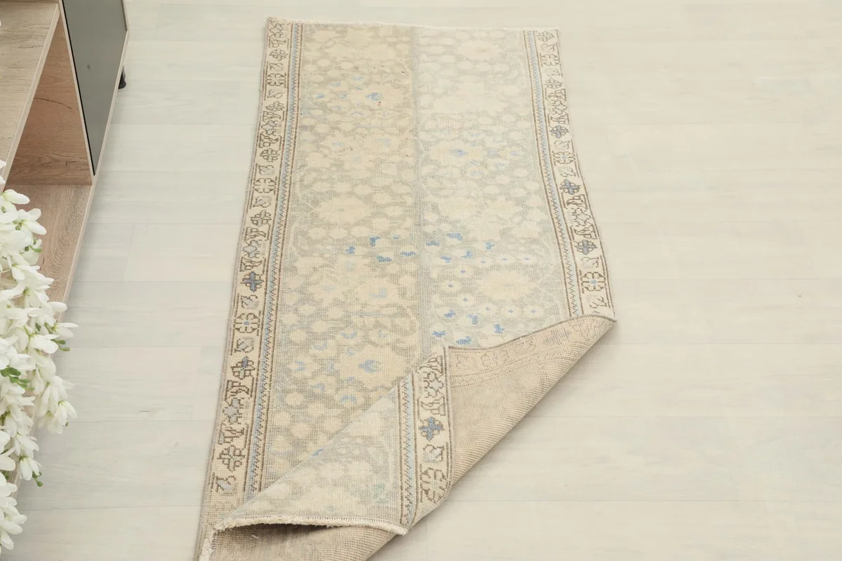 Angled view of the runner with one corner folded back, showing the thickness and texture.