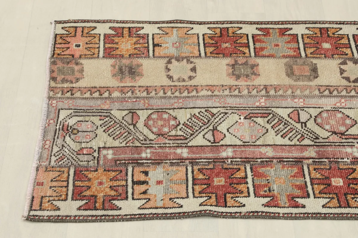 Angled view of the rug's side, showcasing the patchwork-like design elements and border details.