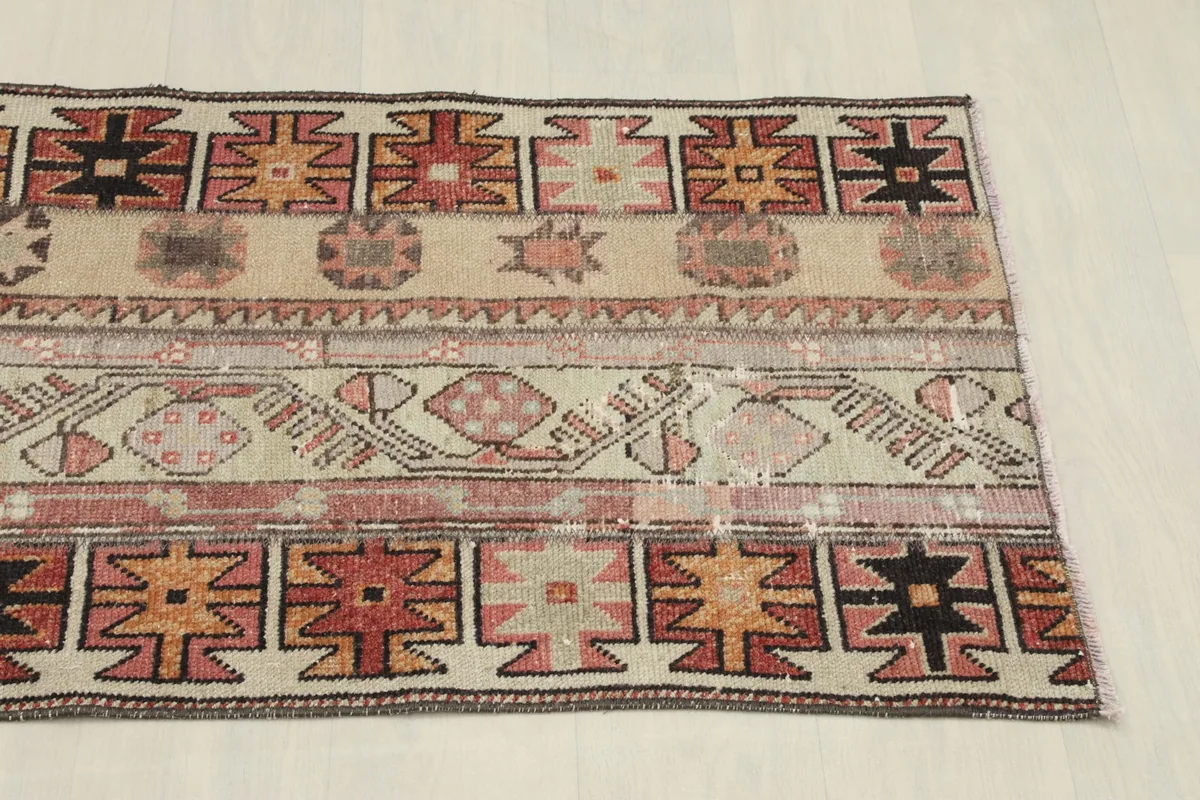 View of the opposite side of the rug, detailing the contrasting geometric patterns and colors.