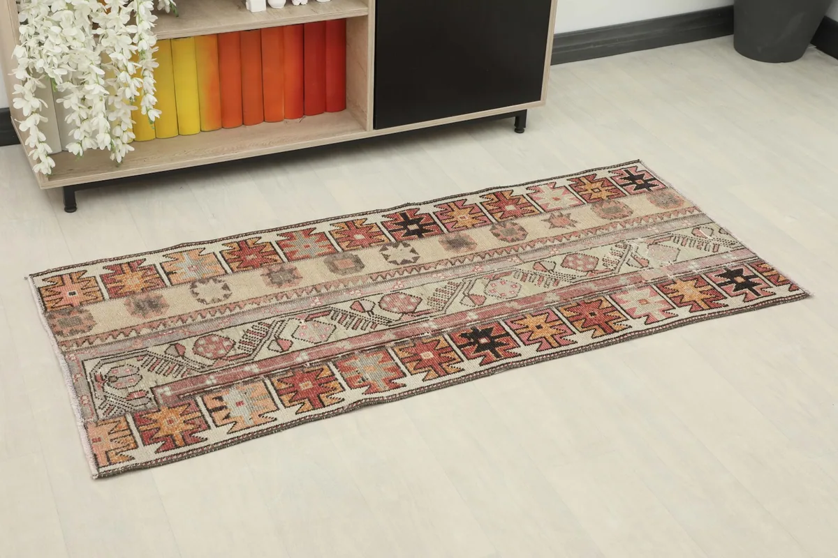 Overhead view of the rug from an angle, showing its placement in a room setting next to shelving.