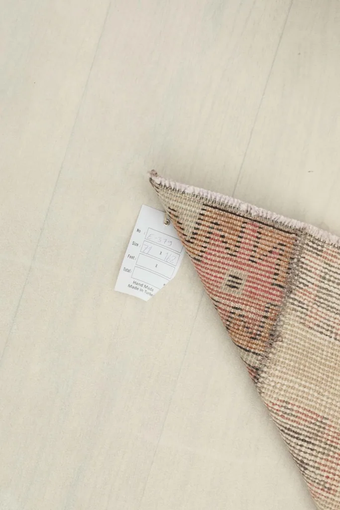 Close-up of the care label attached to the back of the rug.