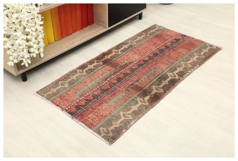 Full top view of the 2'2" x 4'2" vintage Anatolian rug with red, gray, and brown geometric patterns