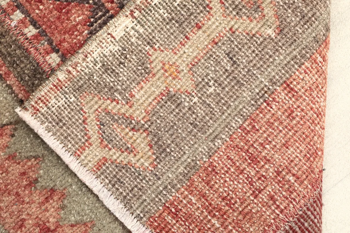 View of the back of the rug, revealing the cotton foundation and hand-knotted construction