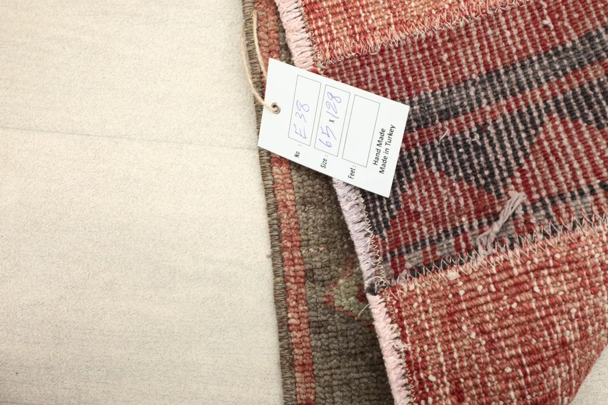Corner of the rug with product tag, confirming hand-made origin and materials