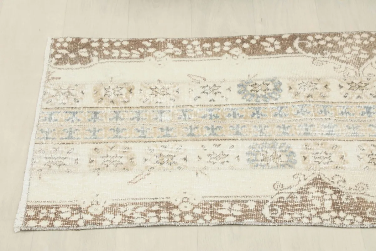 Angled view from one end of the runner, emphasizing the length and the arrangement of the geometric and floral designs.