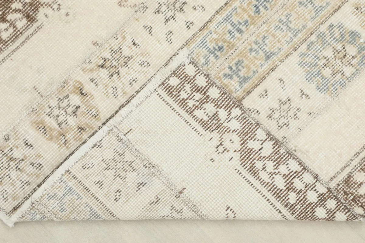 View of the back of the rug, revealing the hand-knotted cotton foundation and the reverse of the pile.