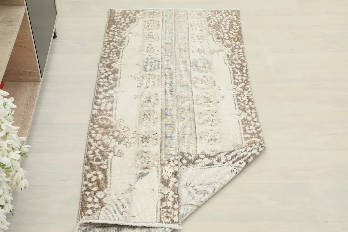 The runner rug partially folded, illustrating its flexibility and how it lays on the floor.