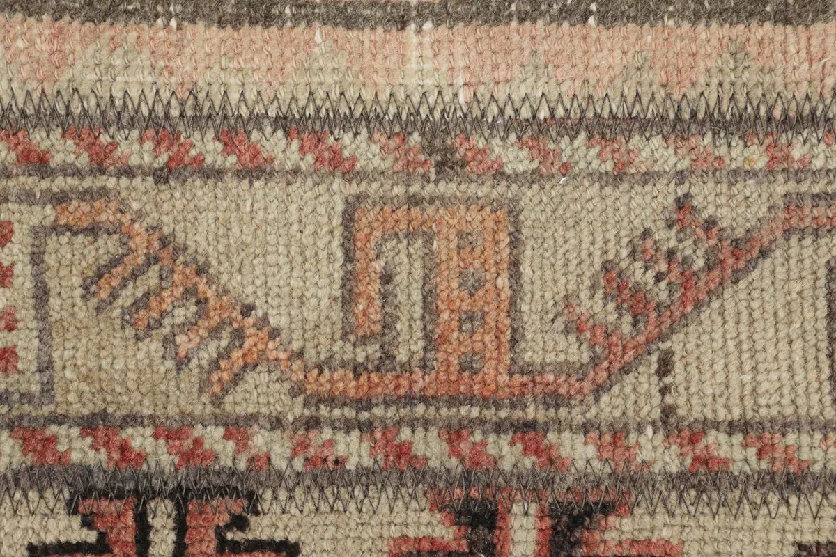 Detail shot highlighting the intricate hand-knotted patterns and wool pile texture.