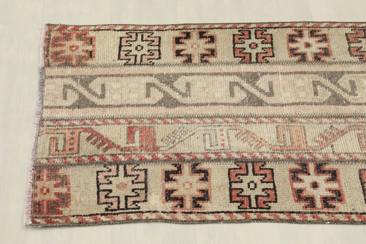 Detail of the rug's patterns and colors from one side, showcasing the tribal motifs.