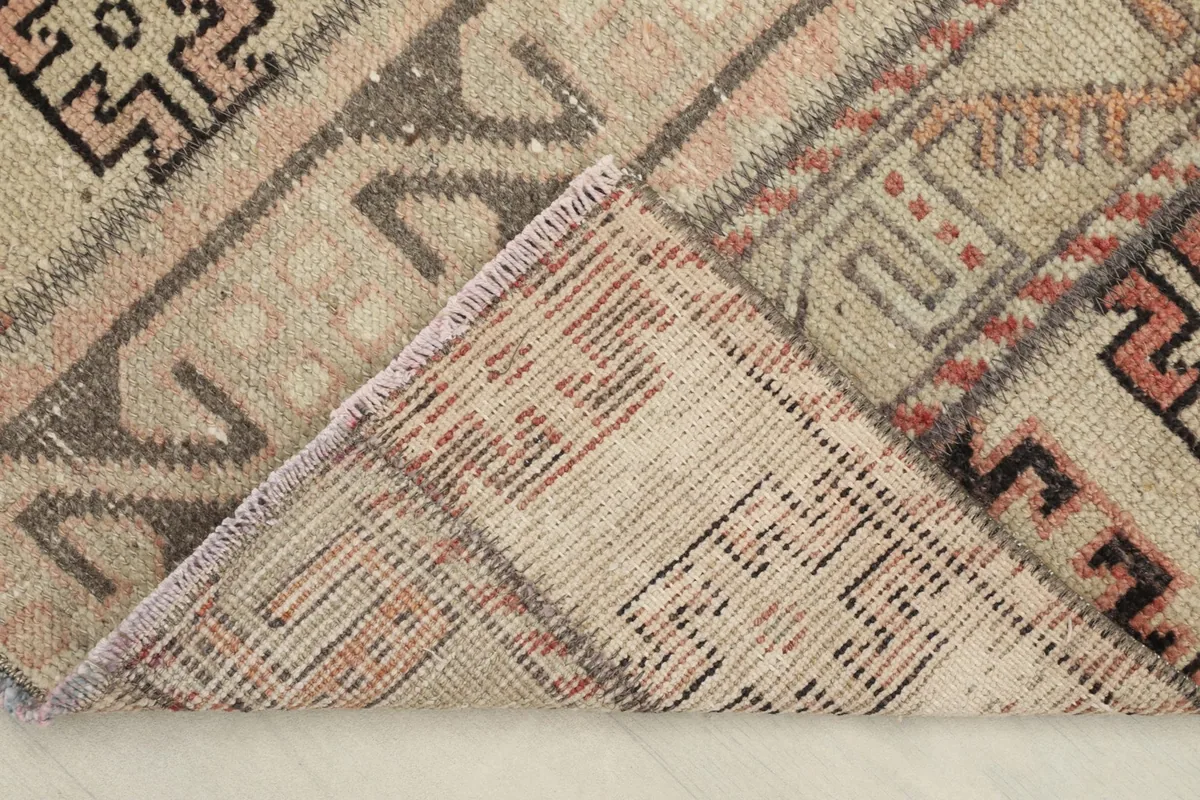 View of the back of the hand-knotted rug, revealing the cotton foundation and knotting.