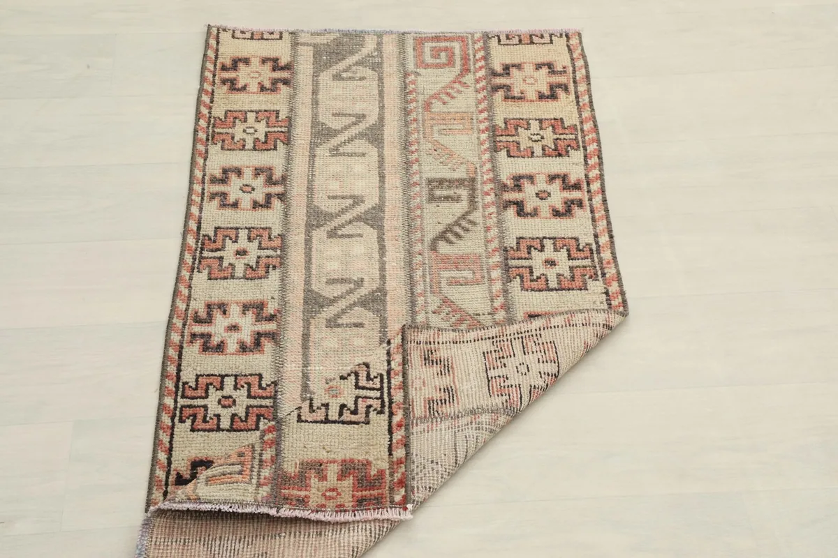 The rug partially folded, illustrating its flexibility and thickness of the wool pile.