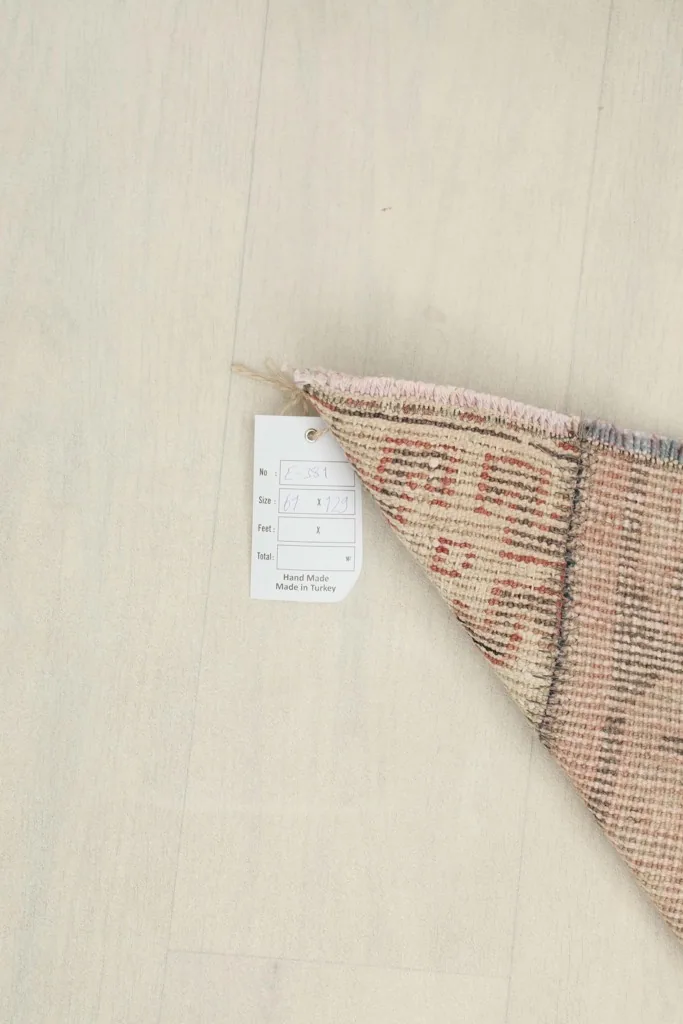 Close-up of the rug's label attached to the corner, showing product information.