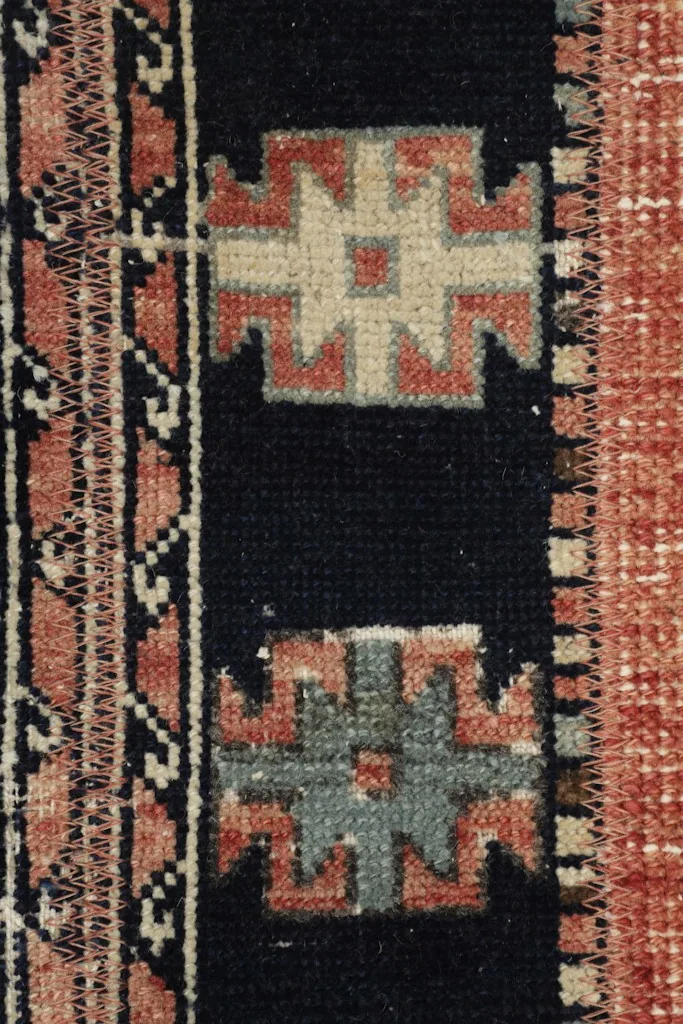 Detailed shot of individual geometric patterns and the texture of the wool pile.
