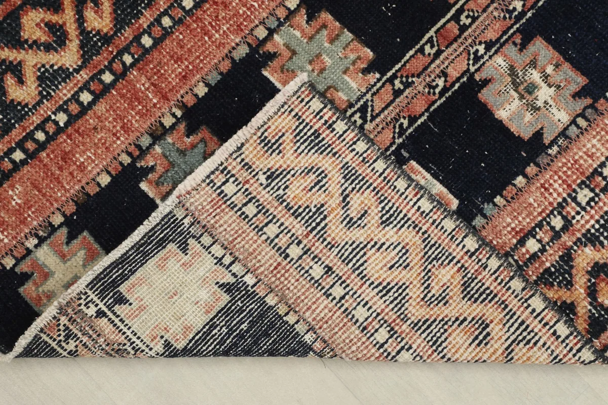 View of the rug's back, revealing the hand-knotted construction and cotton foundation.