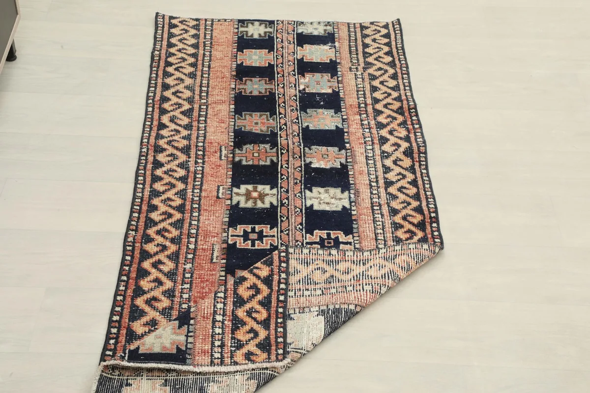 The runner rug partially folded, demonstrating its flexibility and construction.