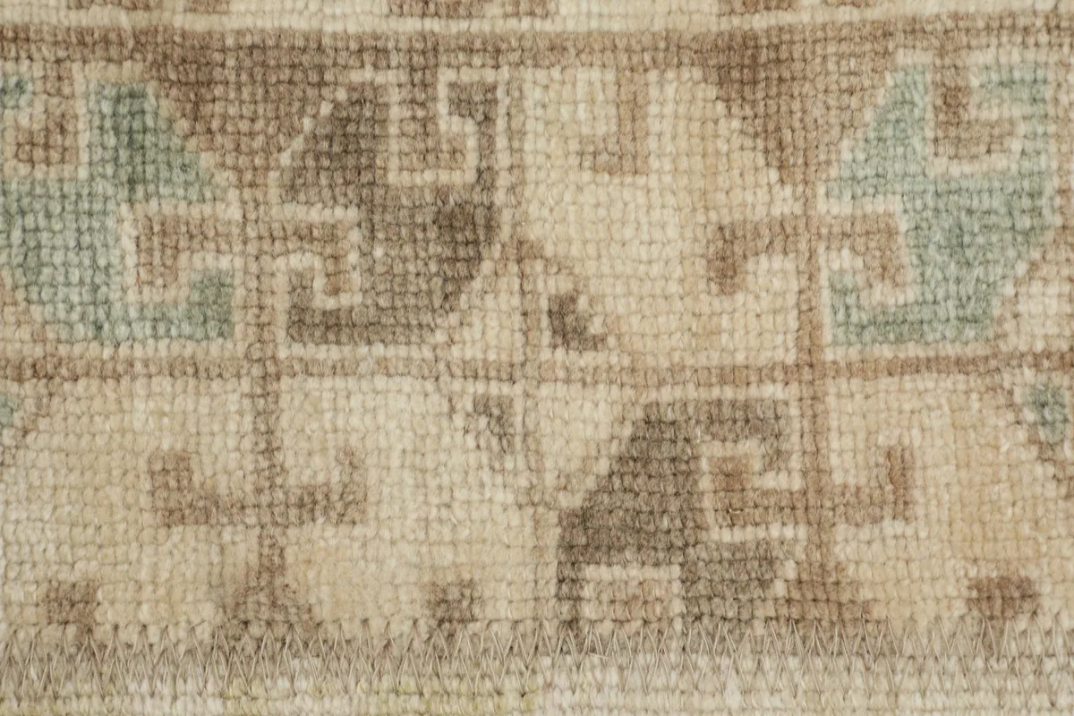 Detailed view of a specific geometric pattern within one of the rug's patchwork panels