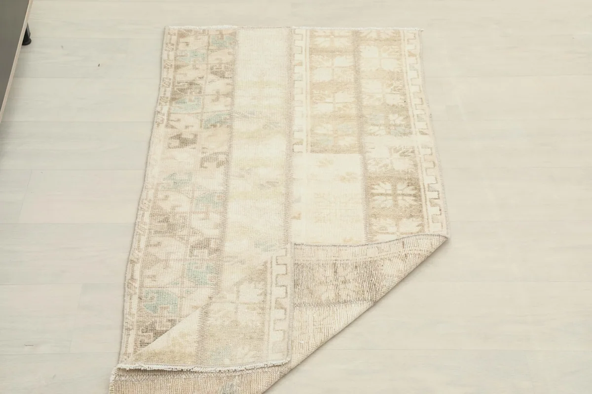 The rug partially folded, demonstrating its flexibility and texture