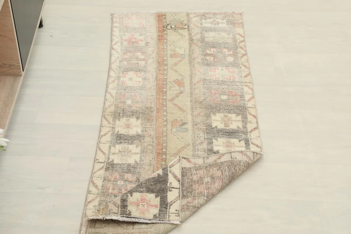 The runner partially folded, showing the flexibility and texture of the vintage wool rug.