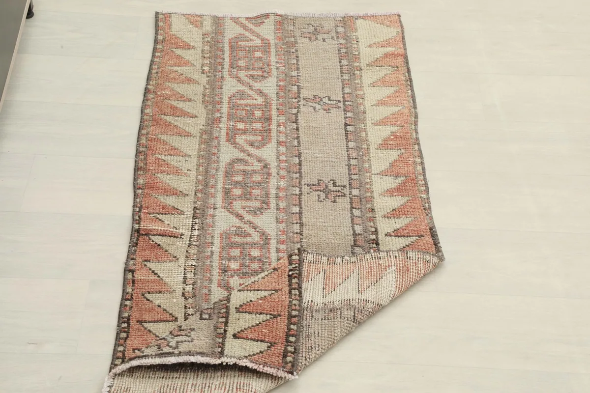 The runner rug partially folded, displaying its flexibility and the full pattern from an angle.