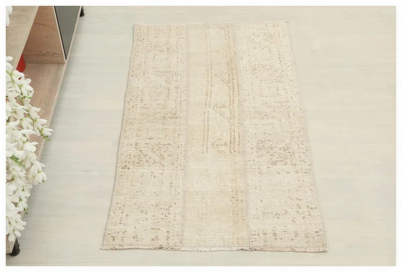 Full overhead view of the 2x4 cream and tan vintage Anatolian rug on a white background