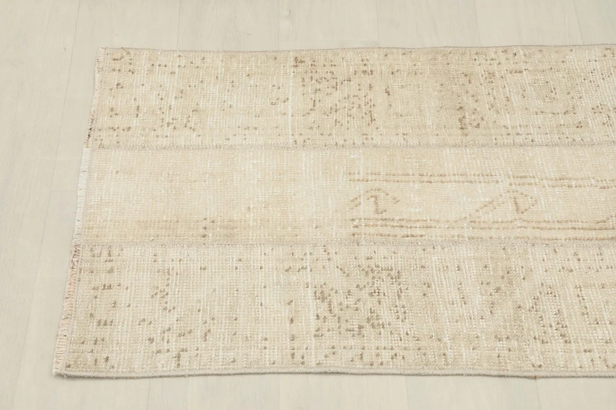 Another angled view, showcasing the rug's full length and the distressed texture of the wool pile