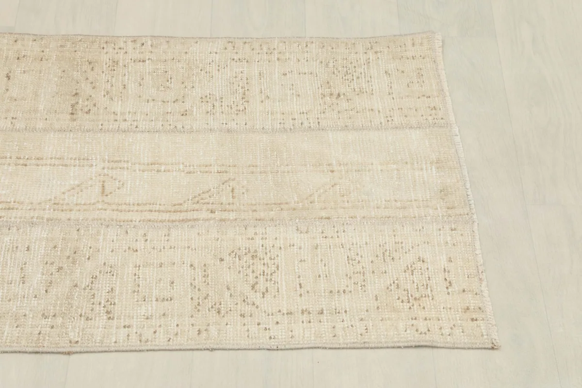 View from the opposite angle, revealing the consistent low pile and soft color variations of the rug