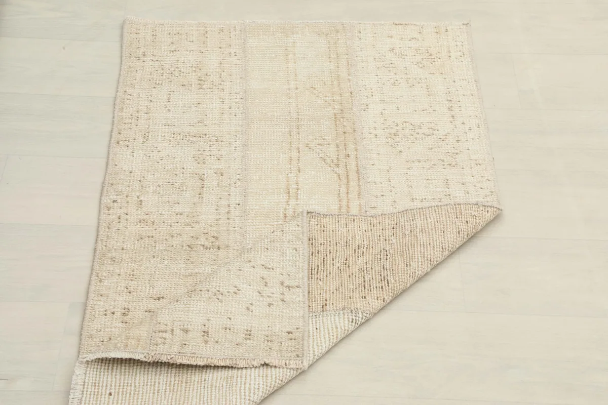 The rug partially folded, demonstrating its pliable nature and the visible texture of the underside
