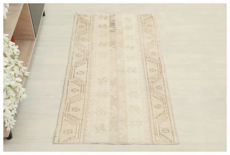 Full top view of the beige geometric vintage Anatolian area rug on a white background