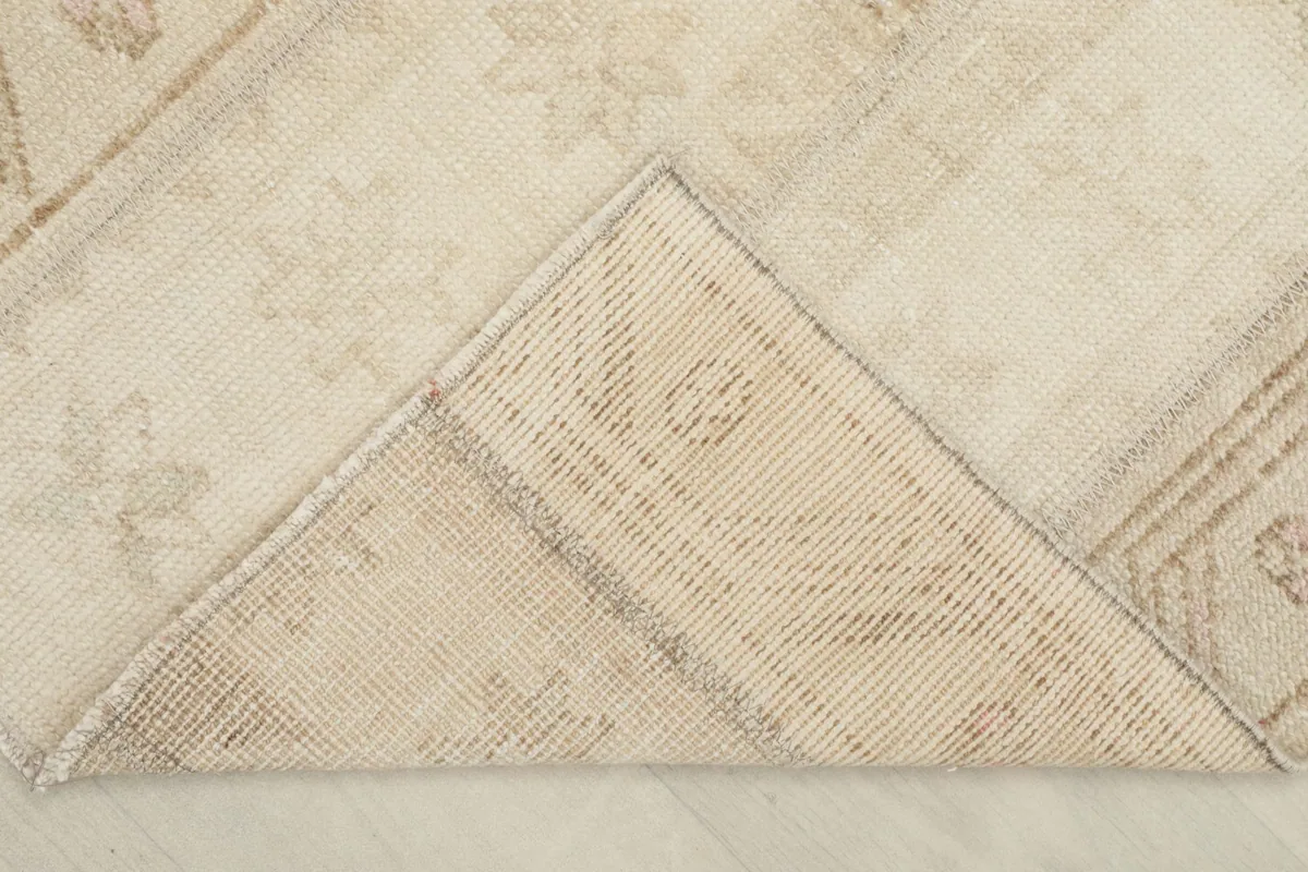 View of the rug's underside, revealing the cotton foundation and hand-knotted construction