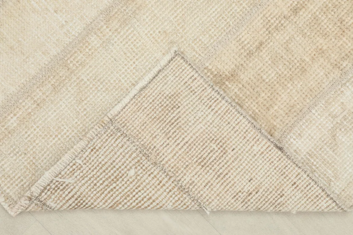 View of the back of the rug, showing the hand-knotted cotton foundation and construction