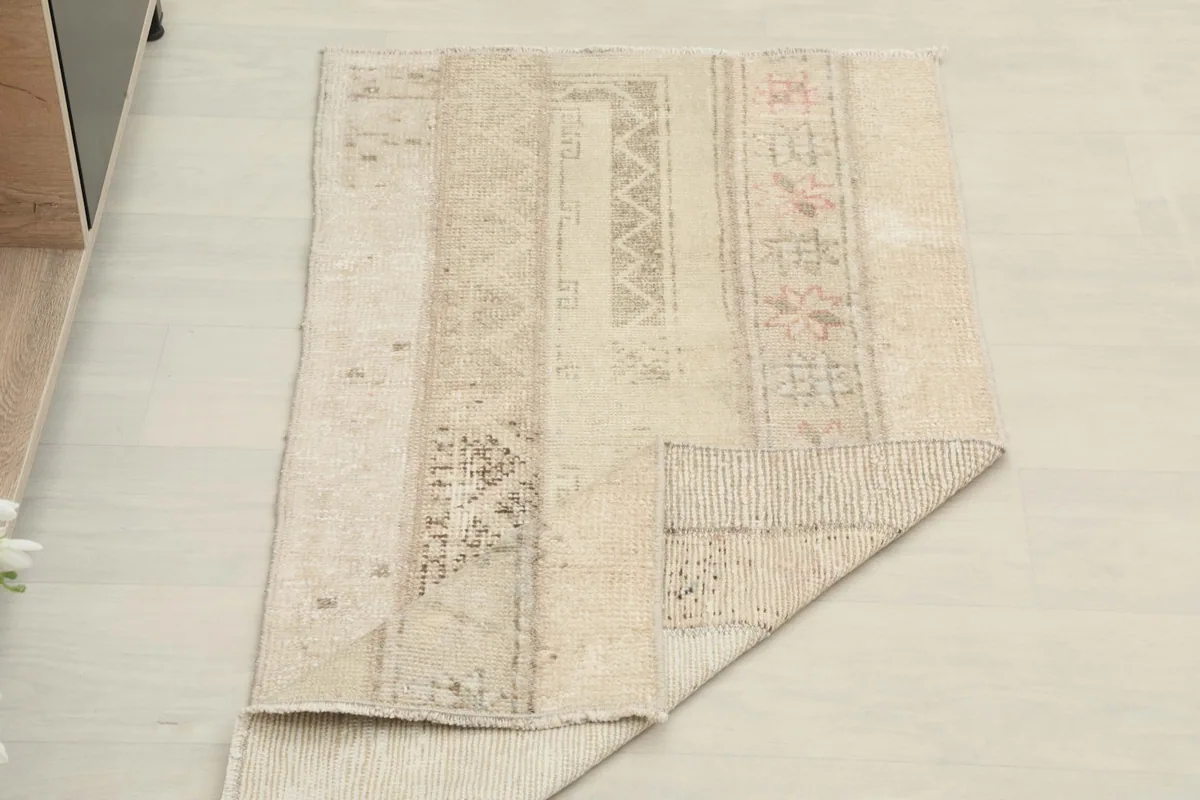 Rug partially folded, displaying the thickness and the back of a portion of the rug.