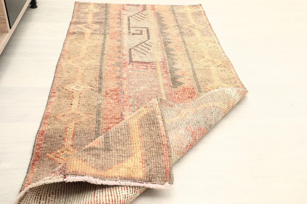 The rug folded to show its flexibility and thickness, with the pattern visible on the top.