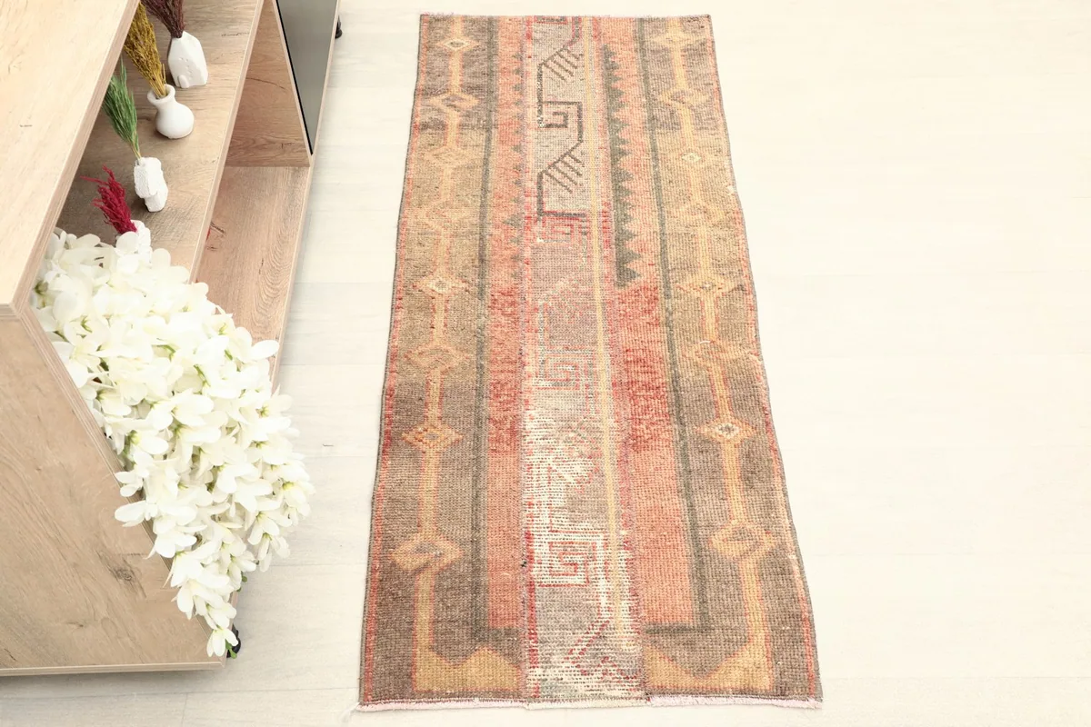 Overhead view of the mini rug, showcasing its full length and striped geometric patterns.