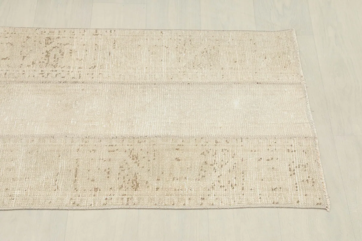 Another angled perspective of the rug, emphasizing the distressed look and color variations